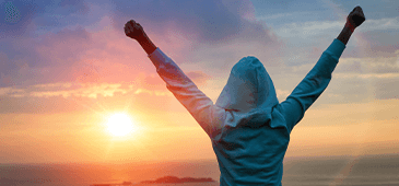 Earlymorningstretch 365X170 Sunset and the back of a girl celebrating with her hands up in victory