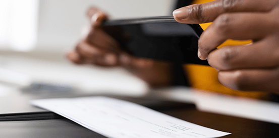 Person taking picture of a cheque with phone