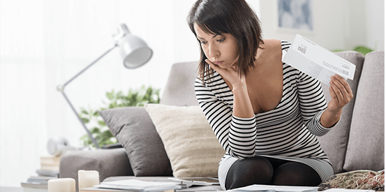 Female on couch looking at paperwork