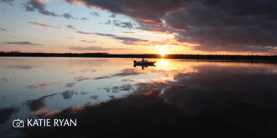 Sunset image of a lake with a boat