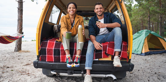Synergy Memberperks Profitshares 553X275 Camping A couple sitting at the beach sharing coffee