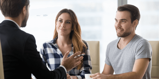 female and male couple meeting with man in suite