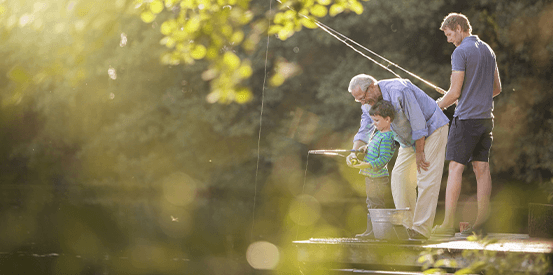 Mature man helping child fish