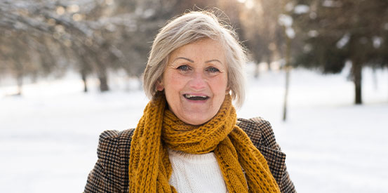 mature person wearing gold scarf