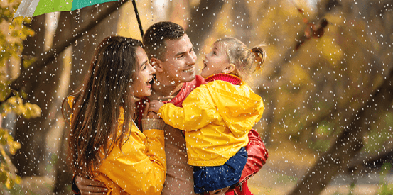 family of three in the rain