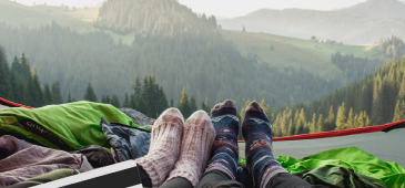 TWO YOUNG ADULTS CAMPING IN THE MOUNTAINS