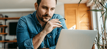 person focused on laptop screen