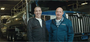 Owners of Mike's Oilfield standing in front of a company truck