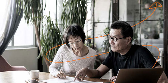 couple reviewing paperwork at a table