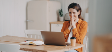 WOMEN LOOKING AT COMPUTER VERY HAPPY