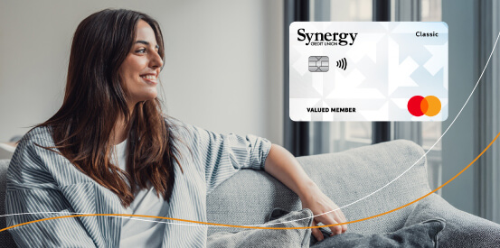Person sitting on a couch looking to the side, with text promoting a balance transfer offer of 12 months of 0% interest.
