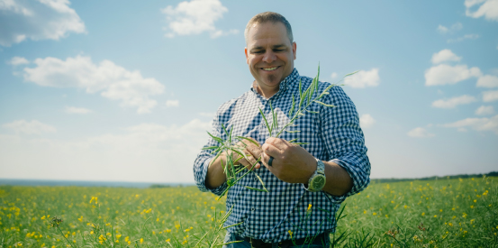 Man smiling checking crops